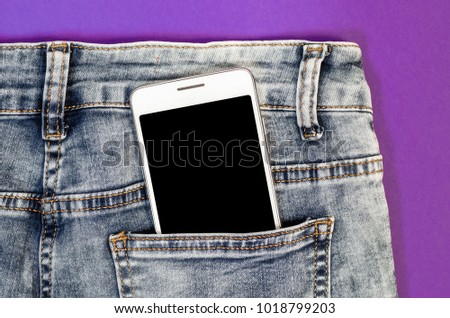 Close Up Bussines Fashion Stylish Smart Phone Screen Copy Space White Mobile in Black Jeans Back Pocket on ultra violet trend color background