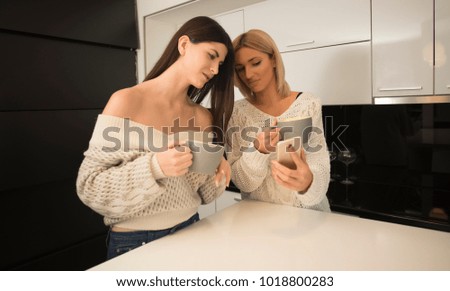 two best female friends making selfie in the kitchen. life stile concept