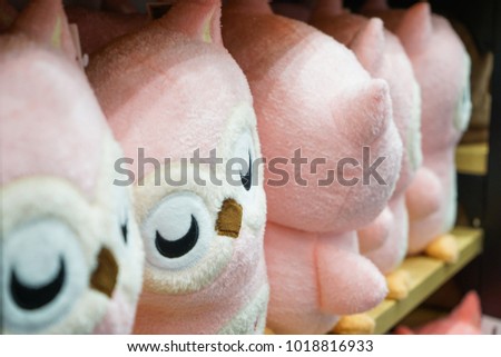 Pretty pink owl dolls in the row on the shelf. Ready for sales., Thailand.