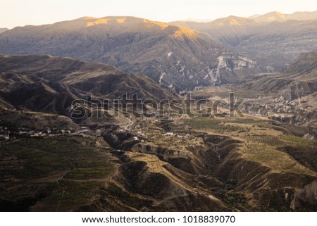 small town in the background of high mountains