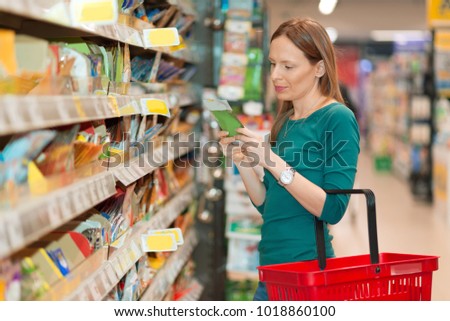 Young woman doing shopping of merchandise in the store