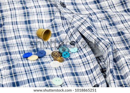 Colorful,different buttons on checkered shirt