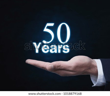 Man hand with 50 years word.