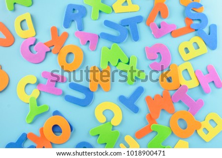 Chaotically scattered alphabet. Beautiful background of multi-colored letters.