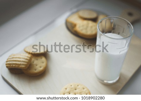 miscellaneous cookies, next to milk on a soft light background, homemade, rustic with light from the window