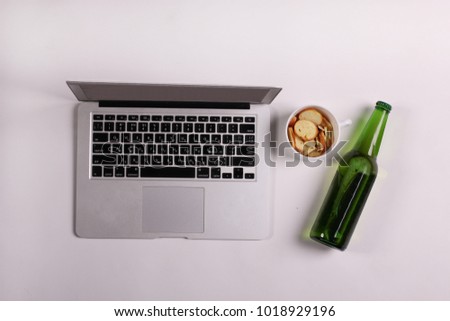 Saint Patrick day. Beer with snacks and laptop
