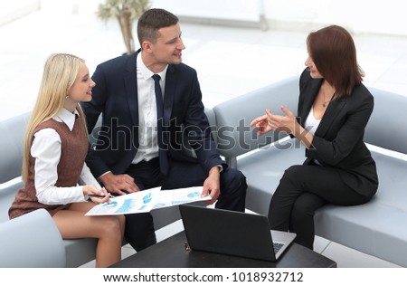 Manager and staff discussing the financial report.