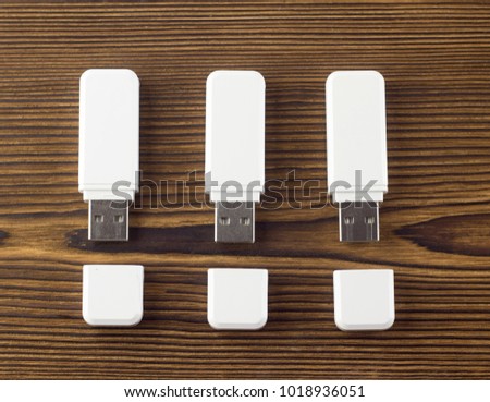 White flash drive on a wooden background