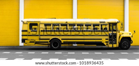 American School Bus on street with Yellow Background - Clean