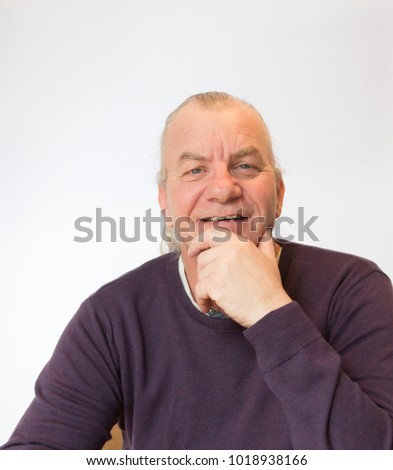 older mature male laughing and smiling on white background in studio, retired happy
