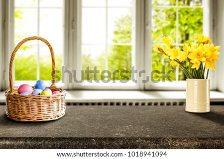Easter table background of free space for your product. Blurred window background. Eggs and flowers decoration. 