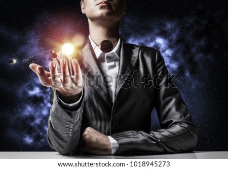 Businessman in suit presenting glowing solar system in his hands with dark cosmic background. 3D rendering.