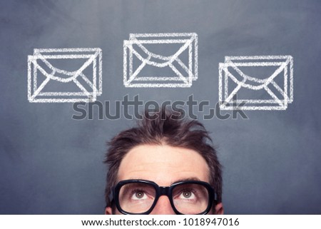 Businessman front of the blackboard with envelope signs