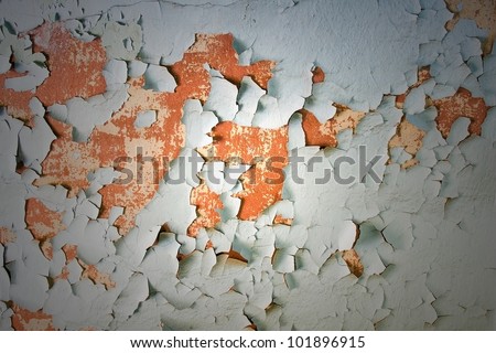 Peeling paint on concrete revealing an orange paint color underneath./ Aged, Cracked, Peeling Paint on Concrete