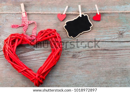 Valentine's day background with red hearts  and a blackboard on wooden planks. Space for text. Valentine's day concept.Top view.