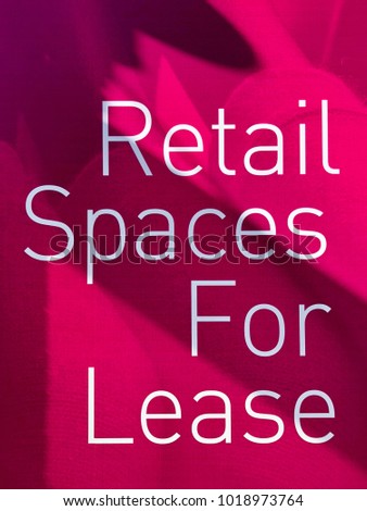 A photo of Retail Spaces For Lease sign written in white letters on pink background in New York City, NY.