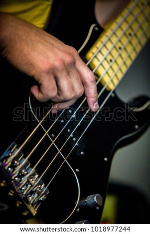 Bass guitar musician playing close up