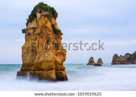 Rocky cliffs of Praia Dona Ana at Lagos, Portugal. Long exposure photography.