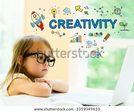 Creativity text with little girl using her laptop