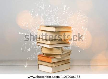 Stack of books on wooden desk