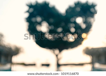 abstract blur and defocused heart shape tree in resort by the sea at sunrise. iconic concept for love, valentine and wedding
