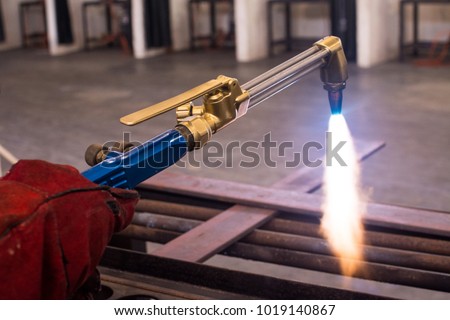 Metal cutting with acetylene and oxygen gas torch. Soft focus due to high ISO and shallow Depth Of Field.   Royalty-Free Stock Photo #1019140867