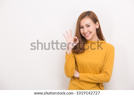 Young woman making OK sign