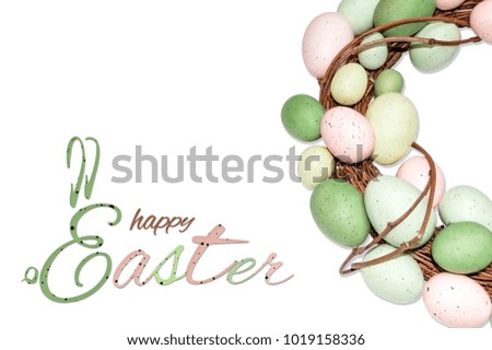 Easter wreath made of pastel color eggs on white background and a greeting saying "happy Easter" with "E" styled as a bunny