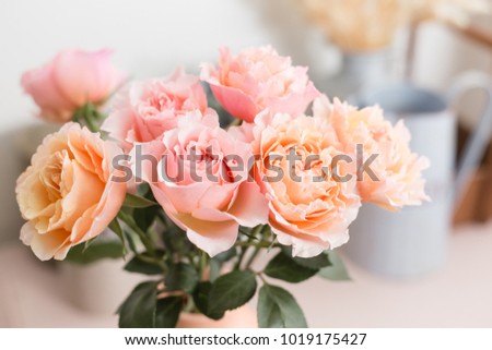 Bouquet flowers of pink roses in glass vase. Shabby chic home decor. florist at a flower shop.