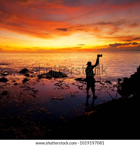 A sunrise with a silhouette of photographer enjoying the scenery