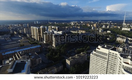 Aerial view of a modern city at sunset. Clip. Top view of the city in summer at sunset