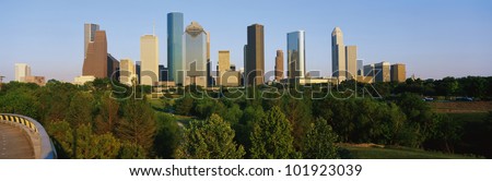 This is the Houston skyline with Memorial Park in the foreground. It is in afternoon light.