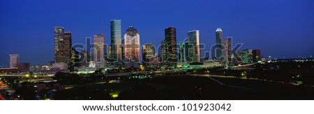This is the Houston skyline at sunset with Memorial Park in the foreground.
