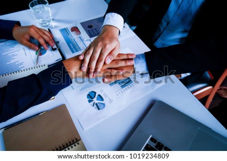 Business Collaboration Concepts : Businessmen join to agree on financial results : Two business associates are business partners working together at the meeting, expressing mutual trust. top view
