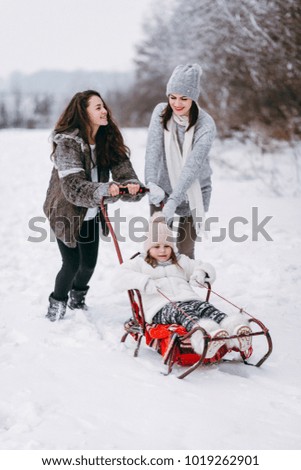 Mother Daughters Walking Winter Park Sledding Smaller Daughter. Have fun on the snow