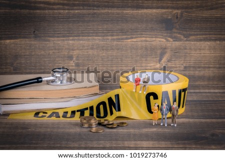 health care and medical background. yellow caution tape on a wood