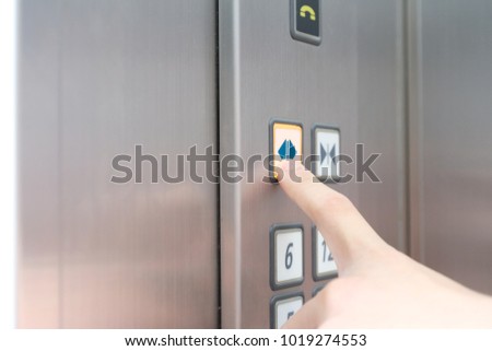 Man finger press on open sign button on elevator