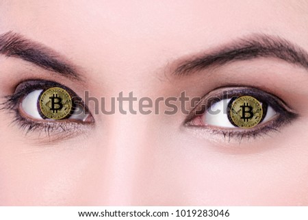 Close up Bitcoin on woman's eyes