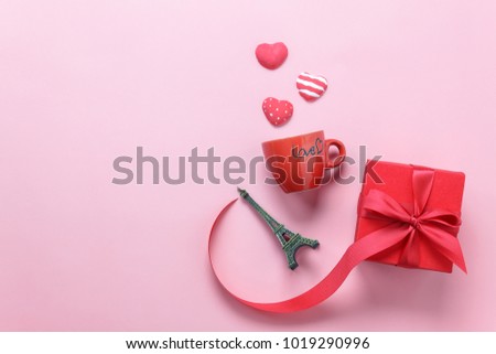 Flat lay aerial image of Valentines day background concept.Table top view accessories gift box with red heart and coffee love cup on modern pink paper at office desk.free space for creative design.