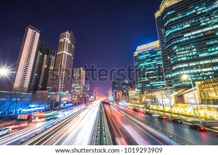 light trail with modern building background in beijing china.