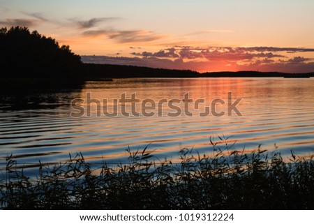 Sunset on the lake Gulf of Finland Baltic sea dramatic sky reflections on the water orange red colorful sky and clouds yellow summer sun background desctop wallpaper twilight autumn