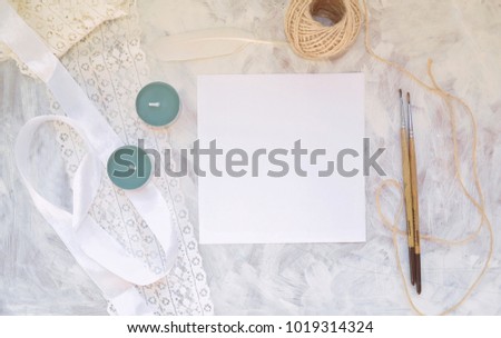 Vintage mockup. Blank paper with place for text, lace, ribbon, twine, brush and pen, candles, black ink and white feather