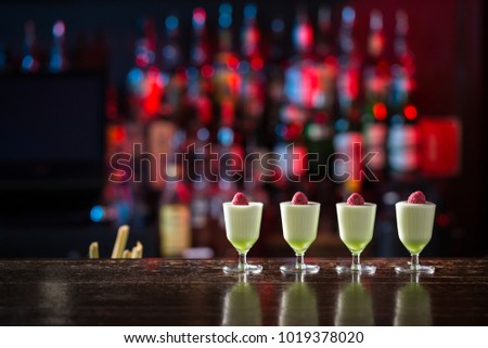 green alcohol shots on the bar