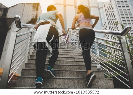 fitness, sport, people and lifestyle concept - happy couple running outdoors.