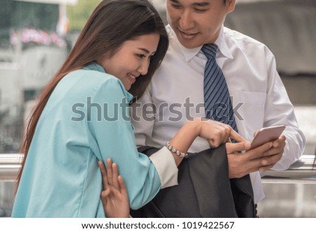 Happy romantic couple in love and having fun  Businessman holding smartphone with woman in love shopping online