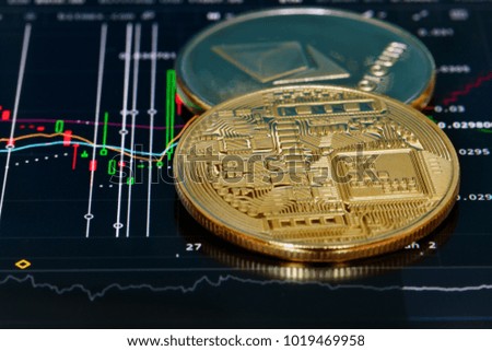 Crypto currency Bitcoin, BTC, Bit Coin. Bitcoin and Ethereum golden coins on a chart. Blockchain technology, bitcoin mining concept