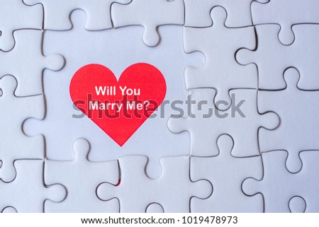 white jigsaw puzzle piece with Red heart and Will you Marry me? Wording. Love and Happy Valentine’s day concepts