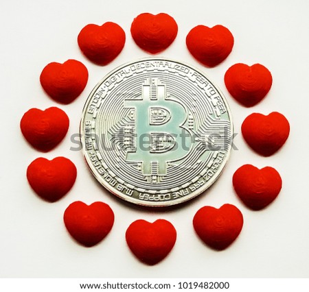 Blurred bitcoin (BTC) surrounded by 12 hearts on white background.