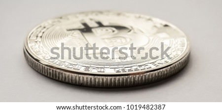 Bitcoin (BTC) - physical coin closeup. Isolated on white background.