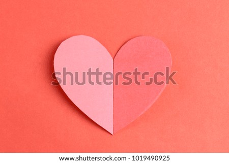 Heart shape of paper on the red cardboard background in Concept for Love and Valentine's Day.
